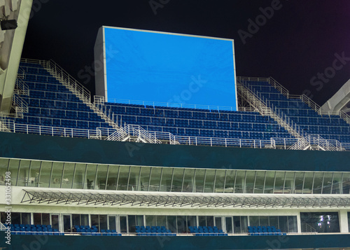 Large LED screen in stadium with empty seats. Scoreboard for sport matches