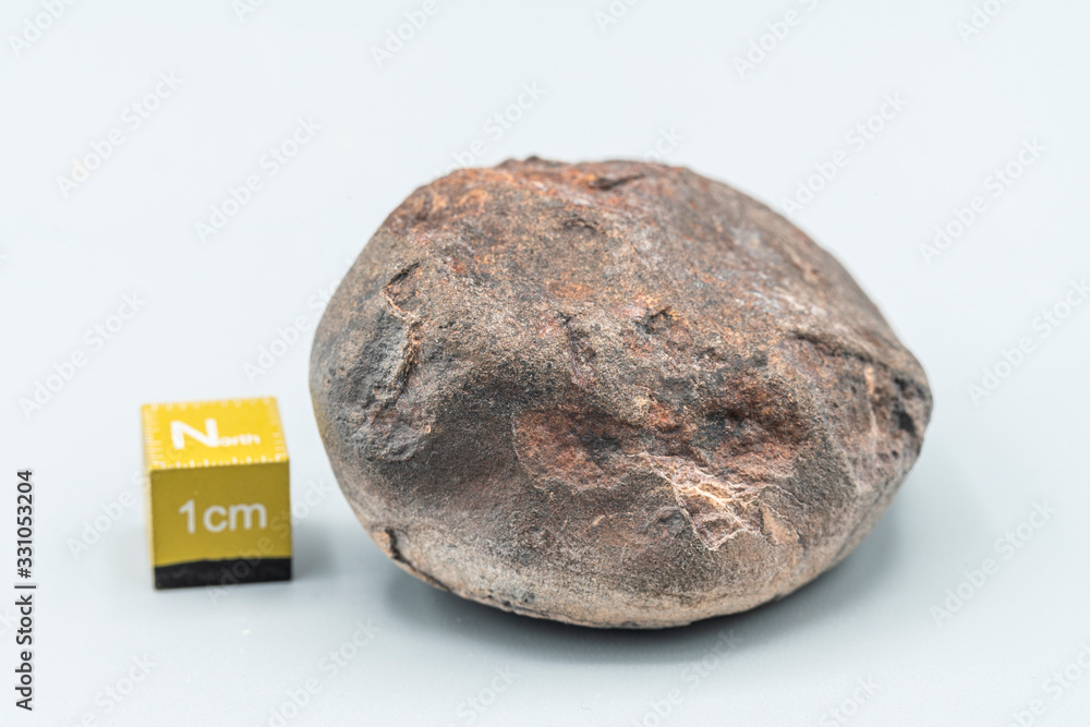 Obraz premium Chondrite Meteorite L6W2 Type isolated, piece of rock formed as an asteroid in the universe at during Solar System creation. The meteorite comes from an asteroid fall impacting Earth at Atacama Desert