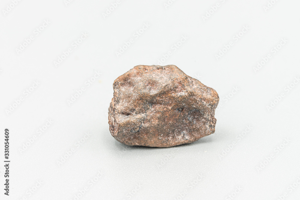 Obraz premium Chondrite Meteorite L6W2 Type isolated, piece of rock formed as an asteroid in the universe at during Solar System creation. The meteorite comes from an asteroid fall impacting Earth at Atacama Desert