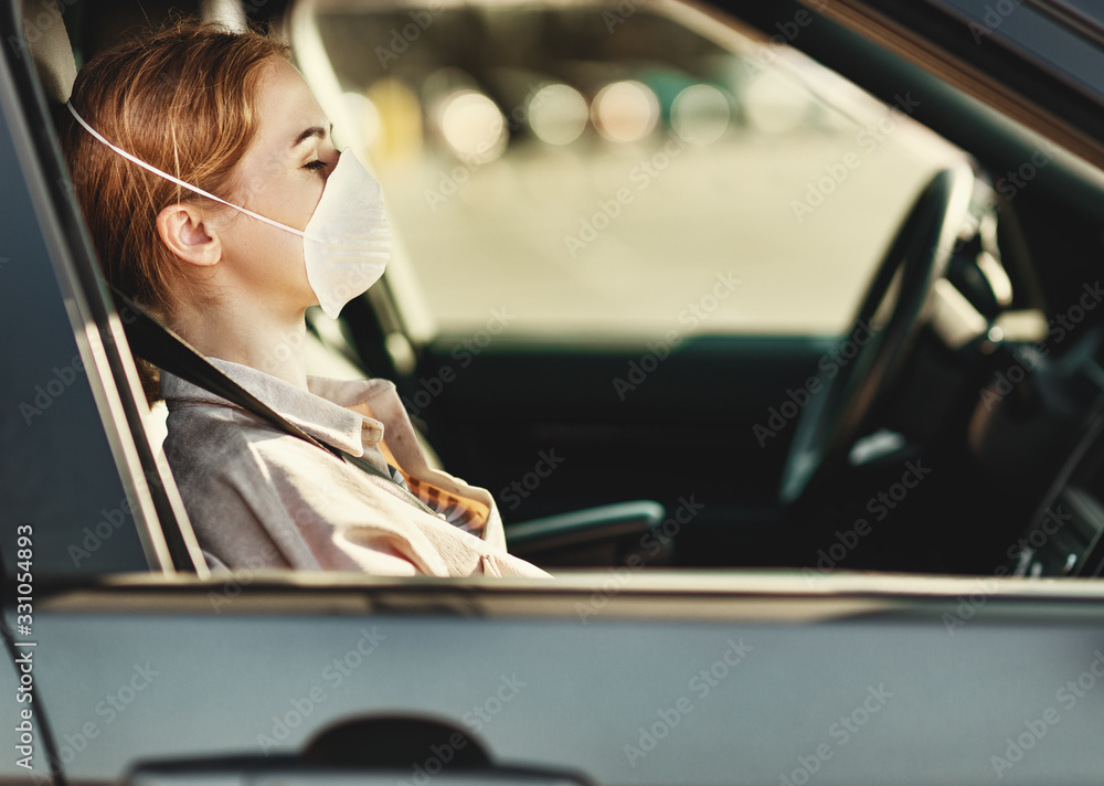 Woman in medical mask sitting in car. Woman in medical mask sitting in car.