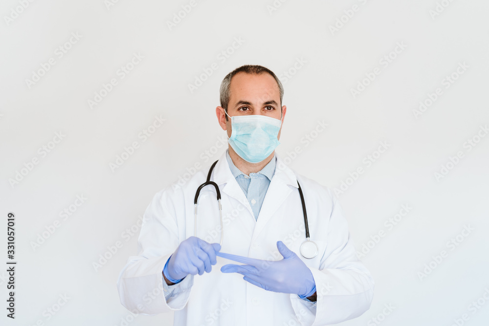 portrait of caucasian doctor using protective gloves and mask. Working on a folder. Chinese Corona virus concept. 2019-nCoV portrait of caucasian doctor using protective gloves and mask. Working on a folder. Chinese Corona virus concept. 2019-nCoV