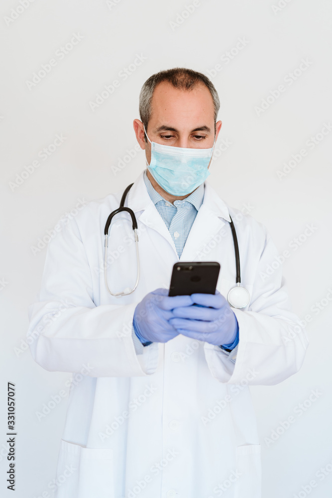caucasian doctor using protective gloves, mask and mobile phone. Chinese Corona virus concept. 2019-nCoV caucasian doctor using protective gloves, mask and mobile phone. Chinese Corona virus concept. 2019-nCoV