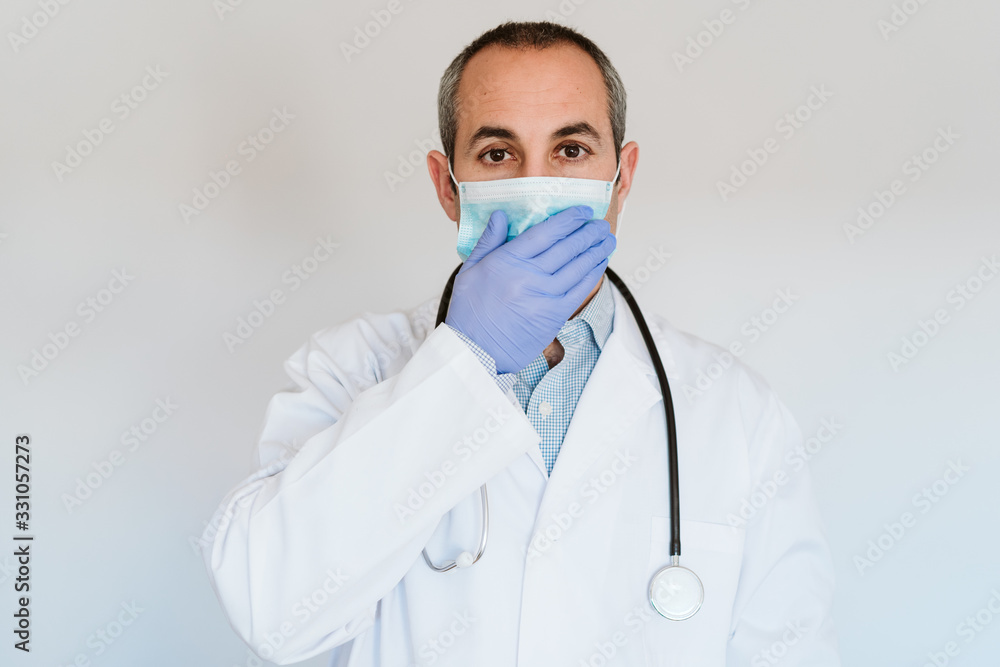 doctor man wearing protective mask and gloves indoors. Corona virus concept