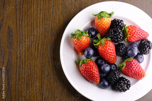 fresh berry fruits in a bowl on table