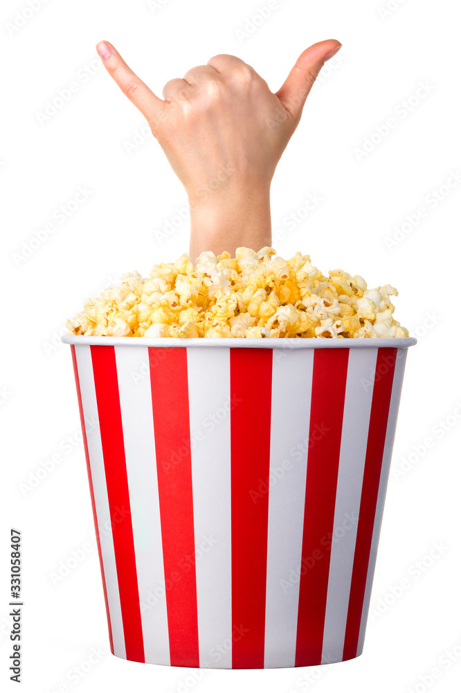 Female hand sticks out of a bucket with popcorn isolated on white background Female hand sticks out of a bucket with popcorn isolated on white background