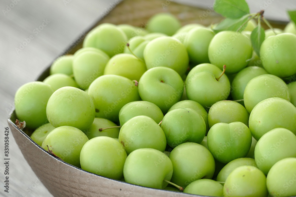 first green sour plums of the year, green plum is very fresh, a container full of green plums, first green sour plums of the year, green plum is very fresh, a container full of green plums,
