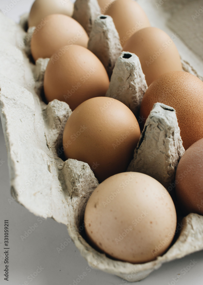 Chicken eggs in cardboard package on white background Chicken eggs in cardboard package on white background