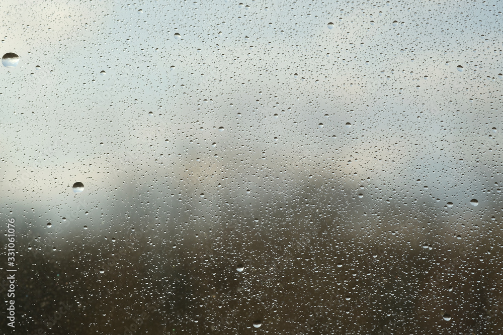 Rain drops on window glasses surface with cloudy background . Natural Pattern of raindrops isolated on cloudy background. Rain drops on window glasses surface with cloudy background . Natural Pattern of raindrops isolated on cloudy background.