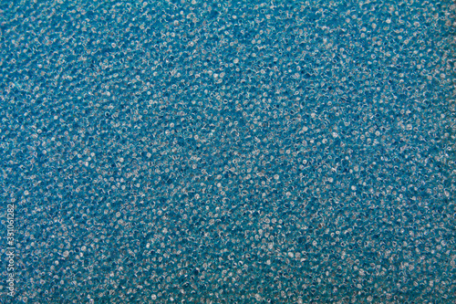 Background in the form of honeycomb structure of blue color. Close-up sponge.