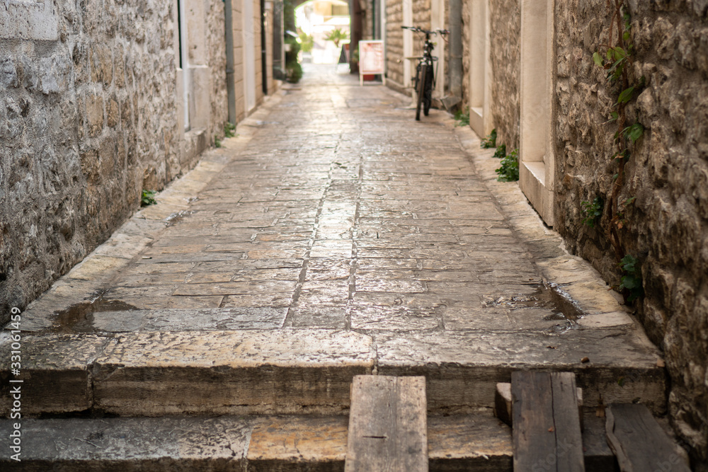 Old narrow street of a European city paved with stones