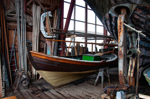Small boatyard museum on the pier. Boat garage with boat in the yard. photo
