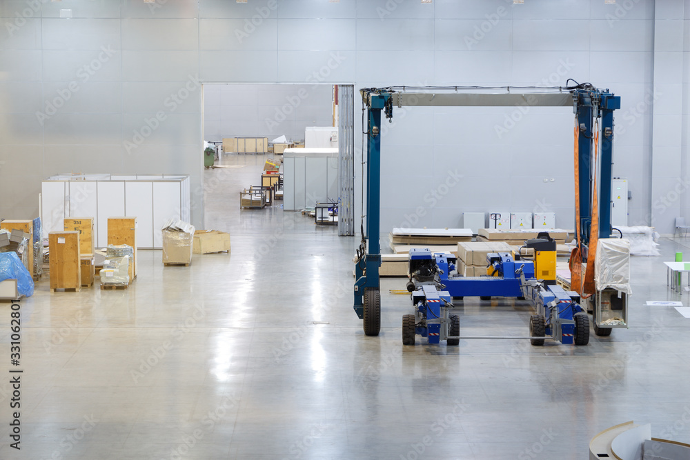 Warehouse with high industrial forklift inside. Stock Photo | Adobe Stock