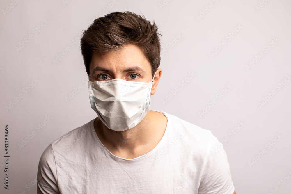 a man in a medical mask. Protection from coronavirus. white background a man in a medical mask. Protection from coronavirus. white background