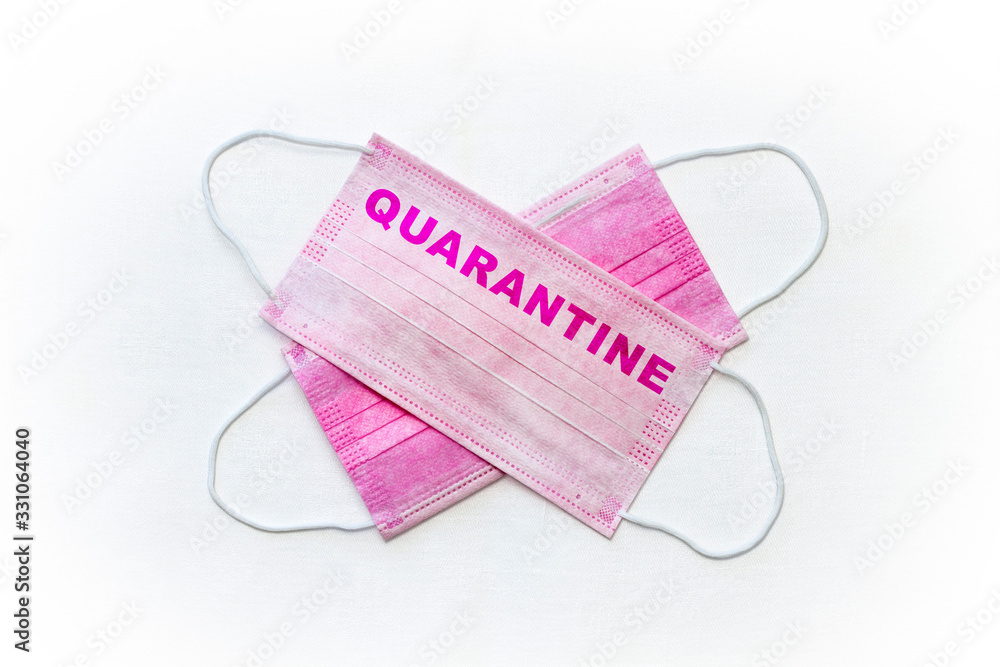 Surgical mask with quarantine sign on. Equipment of bacteria protection with soft rubber ear straps. Surgical mask with quarantine sign on. Equipment of bacteria protection with soft rubber ear straps.