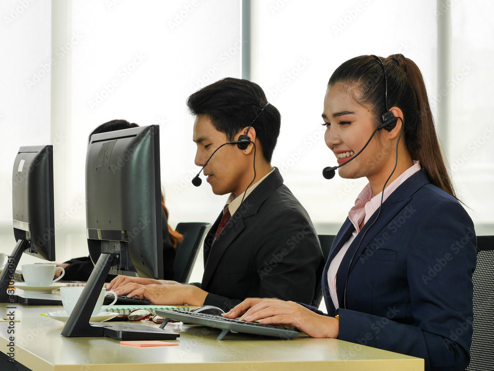 the young skill business asian Thai employee working as the customer service call center representative in the office using computer and headset the young skill business asian Thai employee working as the customer service call center representative in the office using computer and headset