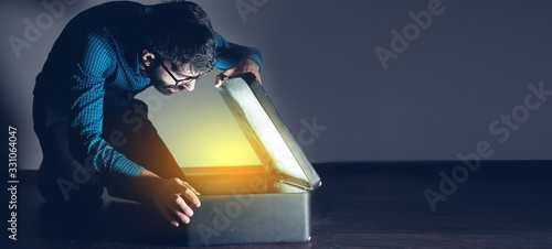 man open gift box on dark background