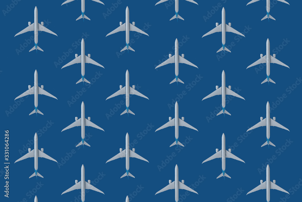 Miniature toy airplane on blue pantone background. Trip by airplane Miniature toy airplane on blue pantone background. Trip by airplane
