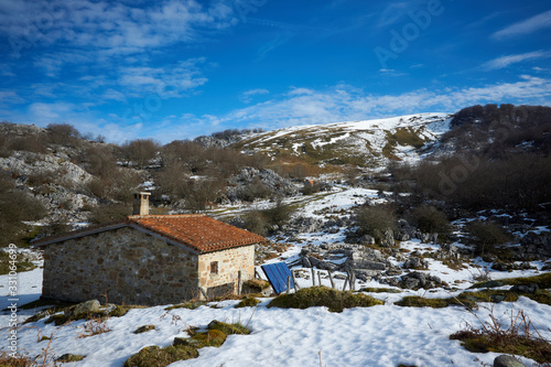 Mountain refuge on Mount Gorbea on a winter day with snow, sun and clouds Solar panel