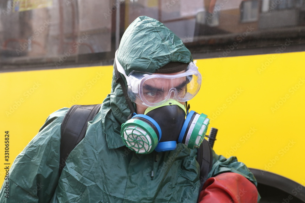 POLTAVA, UKRAINE - MARCH 13, 2020: Doctor in Special Protective Suit Disinfects Coronavirus Bus POLTAVA, UKRAINE - MARCH 13, 2020: Doctor in Special Protective Suit Disinfects Coronavirus Bus