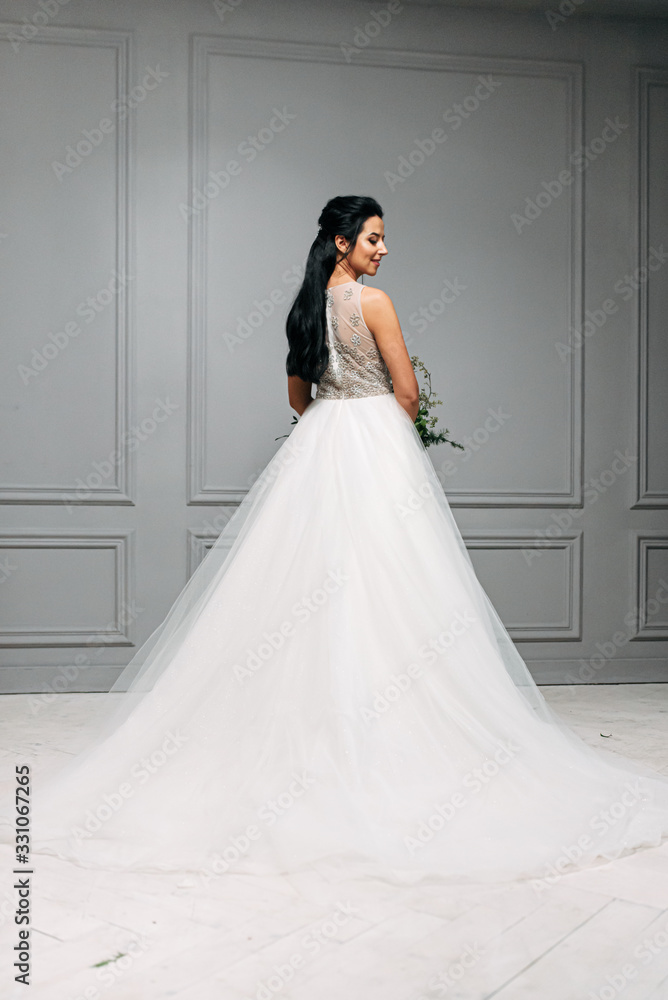 Studio photo of the bride in a chic long dress Studio photo of the bride in a chic long dress