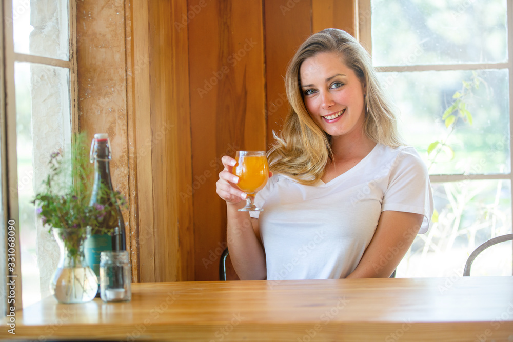 Lifestyle portrait of a person drinking a pint of wheat beer, Hefeweizen, IPA, hazy NEIPA, at a craft brewery Lifestyle portrait of a person drinking a pint of wheat beer, Hefeweizen, IPA, hazy NEIPA, at a craft brewery