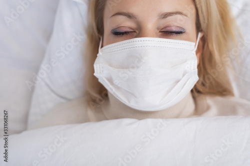 Sick woman lying in bed with high fever. Virus infection.