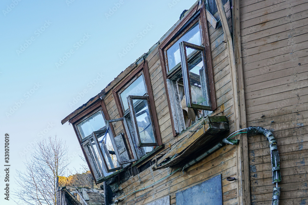 dilapidated wooden house after the fire, deformed exterior wall dilapidated wooden house after the fire, deformed exterior wall