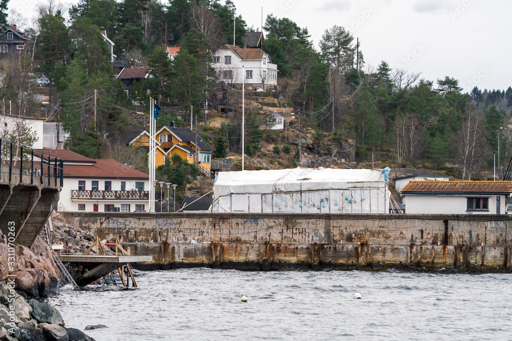 Svestad pier in Nesodden, Oslo - Norway. With diving tent and buildings in the background.