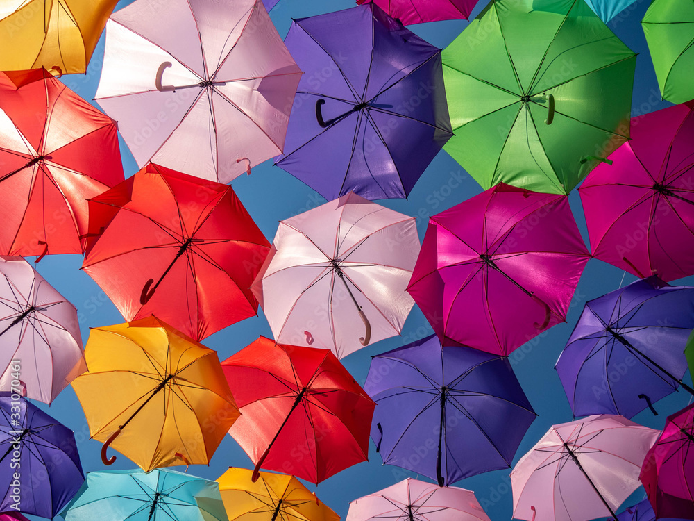 Beautiful colorful umbrellas against a deep blue sky.