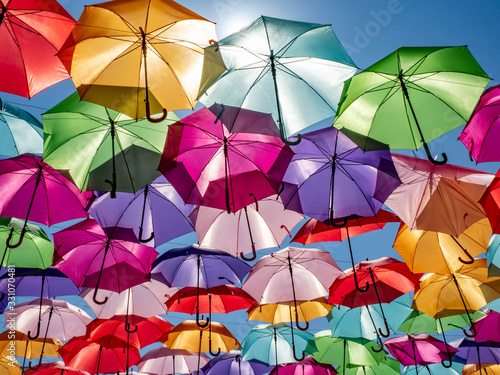 Beautiful colorful umbrellas against a deep blue sky.