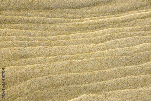 wind and water created sand texture on the seashore