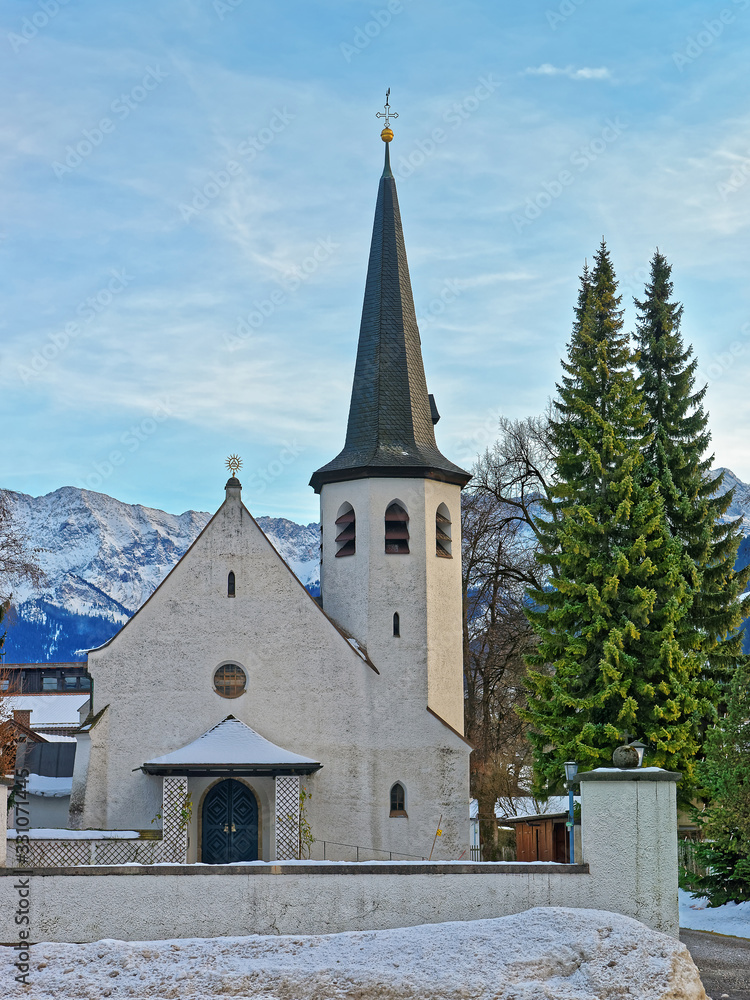 Picturesque old church in Garmisch Partenkirchen on a clear winter day