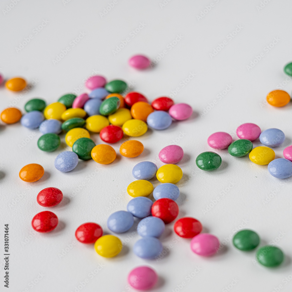colorful medication and candies on white background