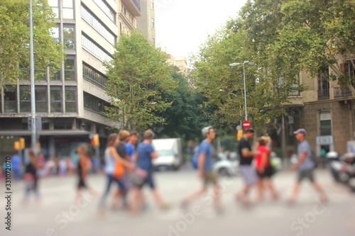 Pedestrians cross the street in Barcelona, Spain.