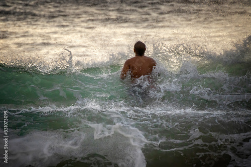 Man Jumps Through Breaking Wave in Ocean