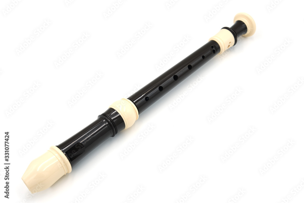 Obraz premium Black flute recorder on a white isolated background, top view