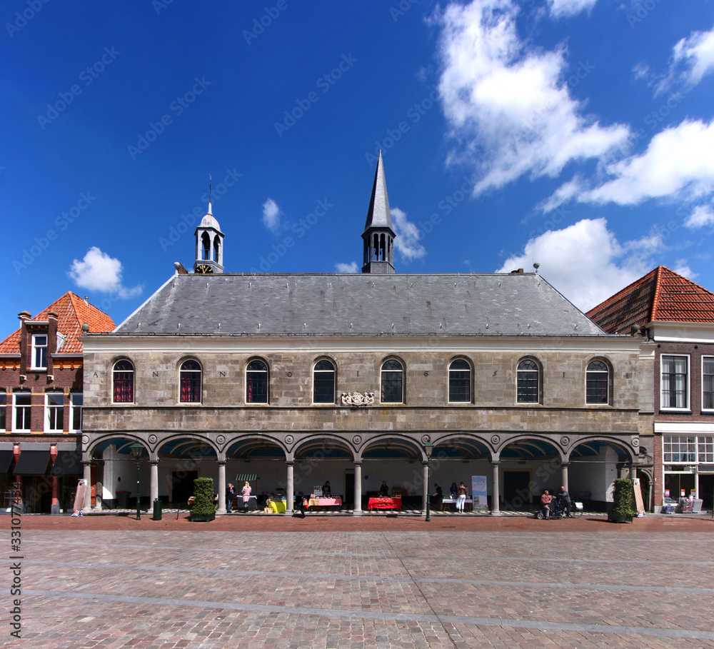 Fototapeta premium Gasthuiskerk church facade with its town hall like loggia at a market square in the old town of Zierikzee, Netherlands