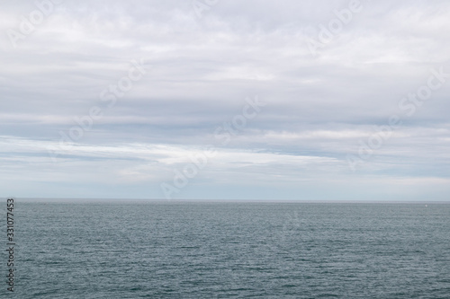 View towards the horizon of the infinite sea in a cloudy day in Donostia, San Sebastian, Spain