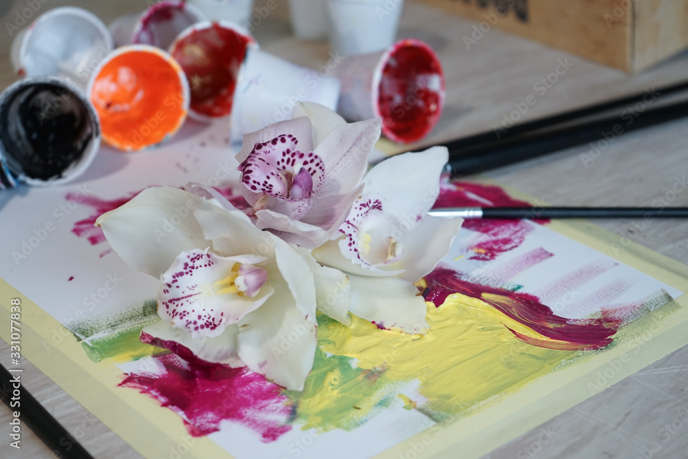 White orchids in art studio ready for painting. White orchids in art studio ready for painting.