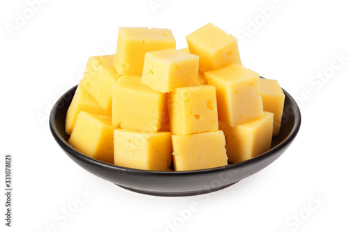 Cut of cheese in a black plate isolated on a white background