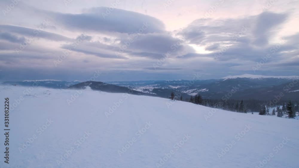 Mountain hazy and cloudy morning snowstorm view. Ski resort Dragobrat, Carpathian mountains, Ukraine. There is slight camera twitch because of strong wind. Mountain hazy and cloudy morning snowstorm view. Ski resort Dragobrat, Carpathian mountains, Ukraine. There is slight camera twitch because of strong wind.