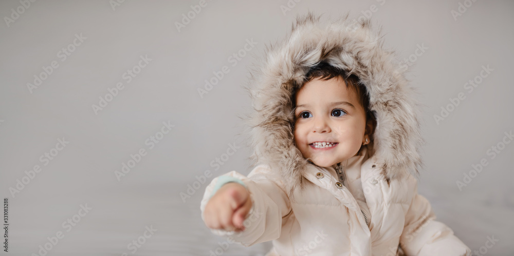 Happy little child girl in white down jacket Happy little child girl in white down jacket