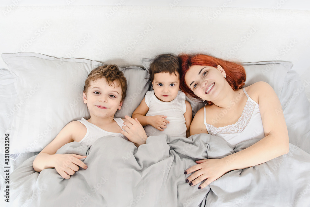 mother with her children son and daughter in white t-shirts waking and having fun mother with her children son and daughter in white t-shirts waking and having fun