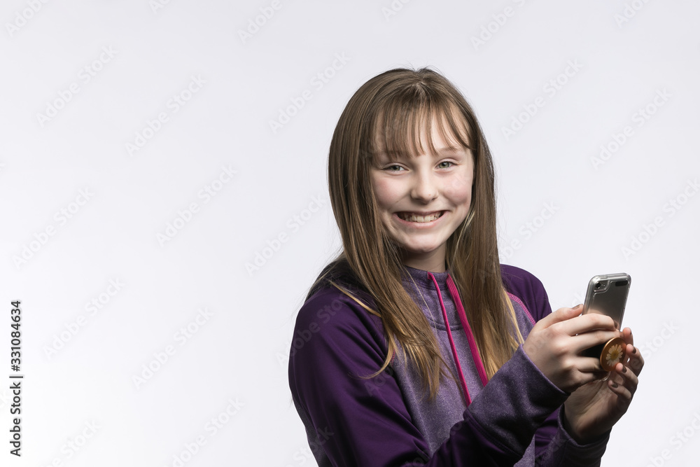 happy young girl with phone in hand studio background happy young girl with phone in hand studio background