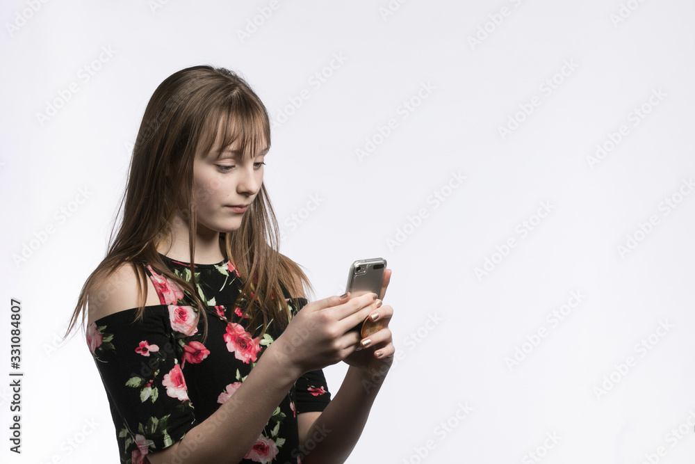 Young girl texting on phone on white background Young girl texting on phone on white background