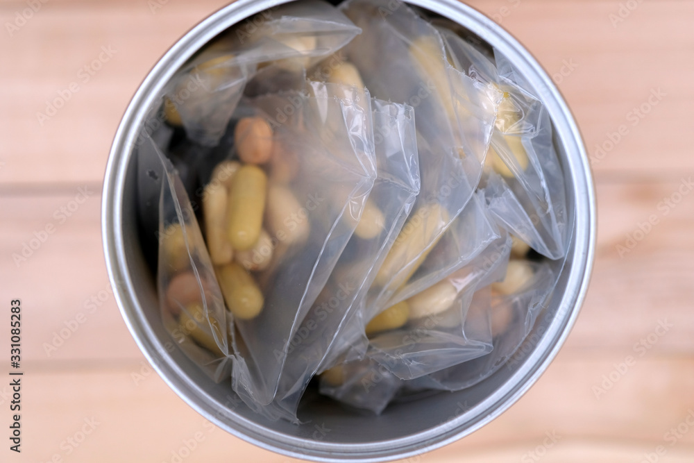 Pills in packages in a metal can top view. Dietary supplements for cartilage and joints. Sports nutrition. Pills in packages in a metal can top view. Dietary supplements for cartilage and joints. Sports nutrition.