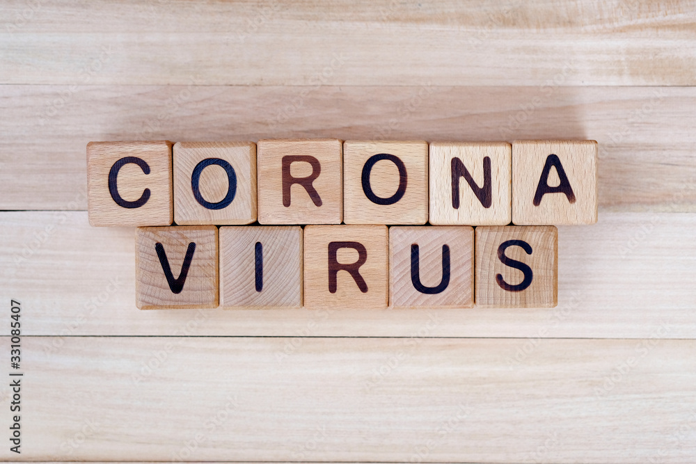 The inscription corona virus on a wooden background, top view. The epidemic of the covid-19 virus. Wooden cubes with letters. The inscription corona virus on a wooden background, top view. The epidemic of the covid-19 virus. Wooden cubes with letters.