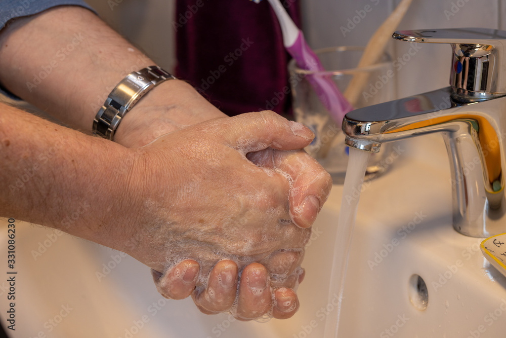 Leipzig,Germany, 03-17-2020, hand hygiene, a man washes his hands with soap at the tap Leipzig,Germany, 03-17-2020, hand hygiene, a man washes his hands with soap at the tap