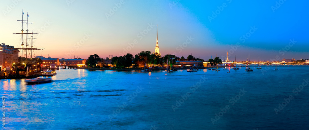 The Neva River, ships, boats and the Peter and Paul Fortress - a night landscape in the center of St. Petersburg The Neva River, ships, boats and the Peter and Paul Fortress - a night landscape in the center of St. Petersburg