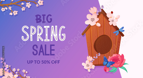 Wooden birdhouse decorated with spring flowers.